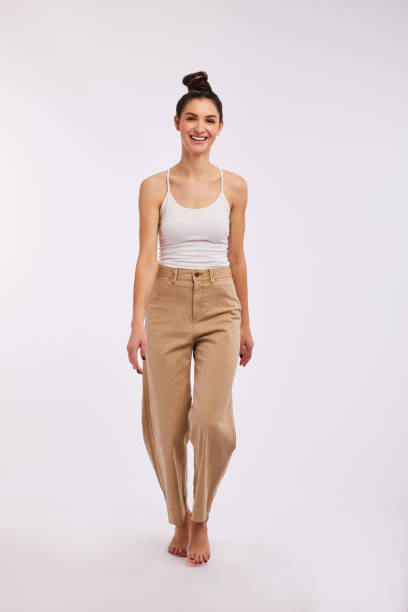 istock Laughing brunette woman walking on a gray background 1205485051