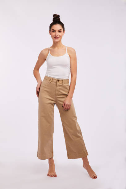 istock Casually dressed woman smiling and standing against a gray background 1205485168