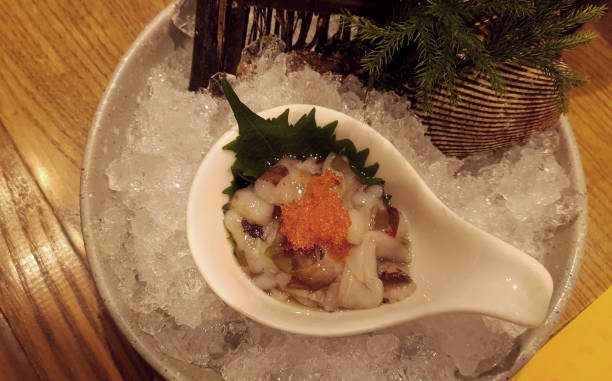istock Tako wasabi raw squid with orange shrimp eggs in white spoon bow 1205487130
