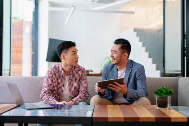 istock Coworkers having an informal meeting in a modern office 1205488298
