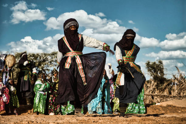 Tuareg men performing traditional dance Tuareg men performing traditional dance during Ghat Festival of Culture which is held every December in Ghat City (about 1,360 km (845 miles) south of the Libyan capital, Tripoli) libyan culture stock pictures, royalty-free photos & images