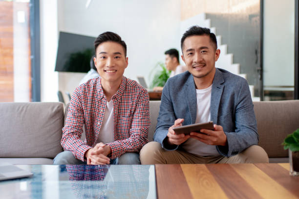 istock Portrait of two men in a modern co-working office 1205488343