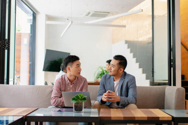 istock Coworkers having an informal meeting in a modern office 1205488347