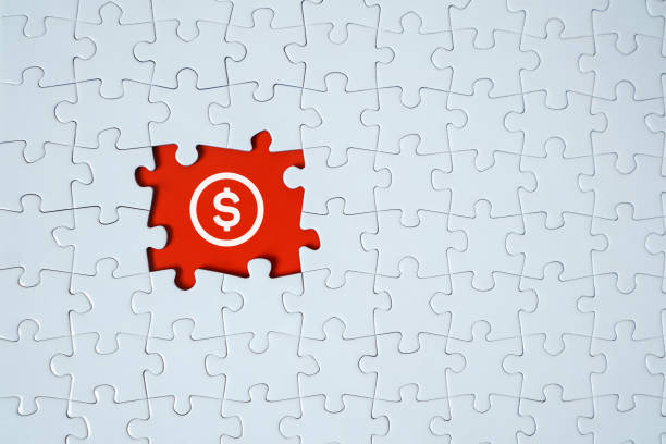 istock An American dollar sign on a jigsaw puzzle frame. 1205490807