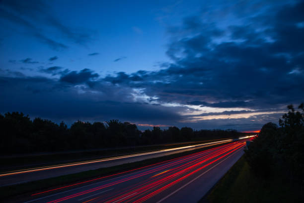 istock Night traffic scene with light trails on highway long exposure 1205492297