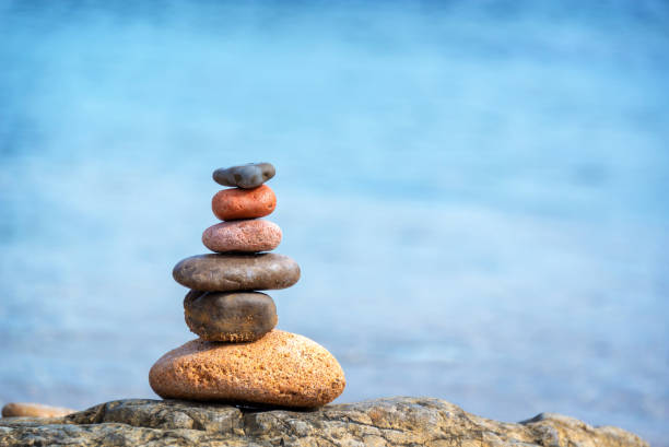 Pile of pebbles on a beach, blue water background