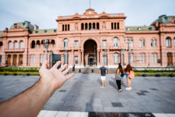 istock Man's hand showing Casa Rosada 1205494400