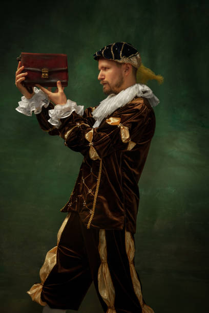 istock Medieval young man in old-fashioned costume 1205496147