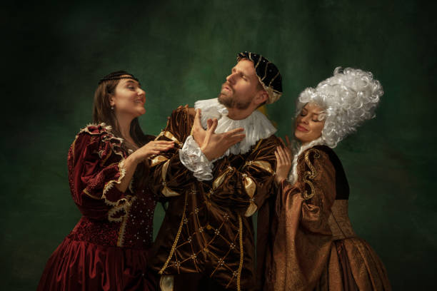 istock Medieval young man and women in old-fashioned costume 1205496185