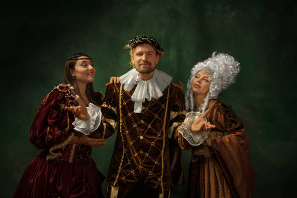 istock Medieval young man and women in old-fashioned costume 1205496186