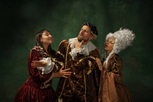 istock Medieval young man and women in old-fashioned costume 1205496187