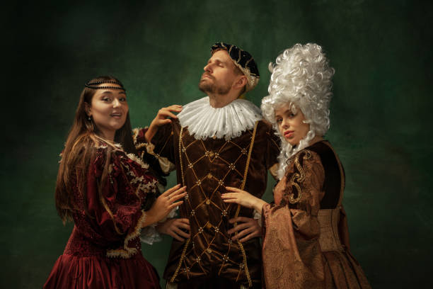 istock Medieval young man and women in old-fashioned costume 1205496195
