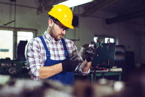 istock Industrial worker inspector measuring detail with Vernier Caliper 1205496425