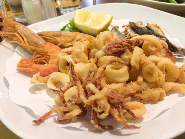 Italian Mixed fried fish, shrimp and squid platter Italian Mixed fried fish, shrimp and squid platter. Isolate close view fritter photos stock pictures, royalty-free photos & images