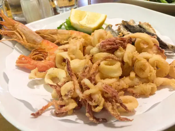 Italian Mixed fried fish, shrimp and squid platter. Isolate close view