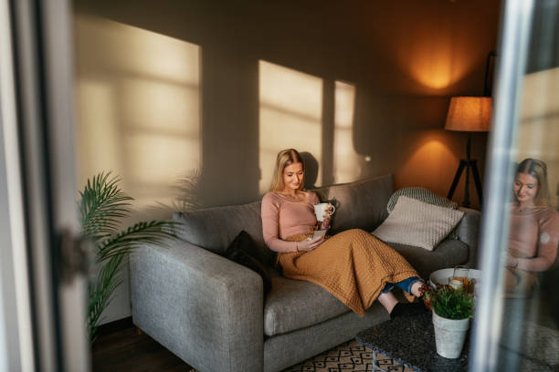 Blonde young women at home using phone