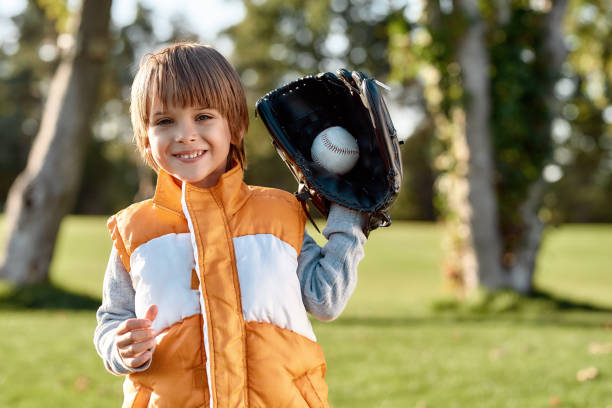 istock Skillful player. Little boy is ready to play baseball 1205497209