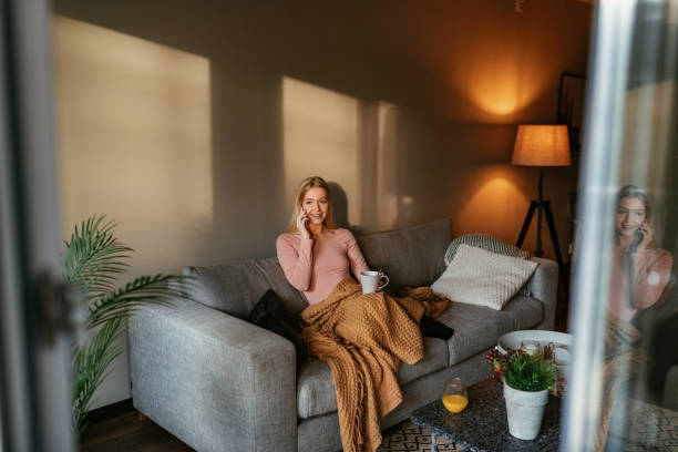 istock Blonde young women at home using phone 1205497247