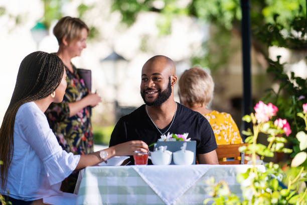 istock Happy Couple on a restaurant veranda having a meal 1205497310