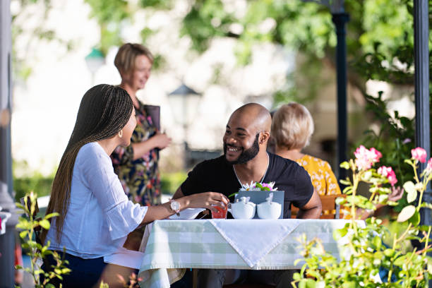 Couple on a restaurant veranda having a meal laughing together