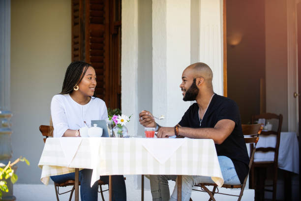 istock Couple on a bed and breakfast porch having brerakfast 1205497529