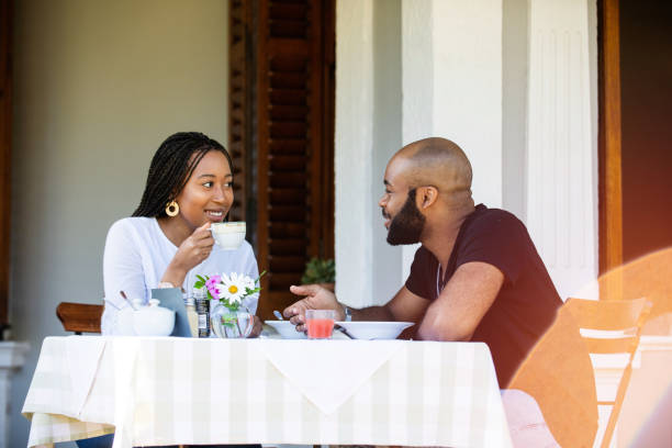istock Couple on a restaurant veranda having a meal gossiping 1205497573