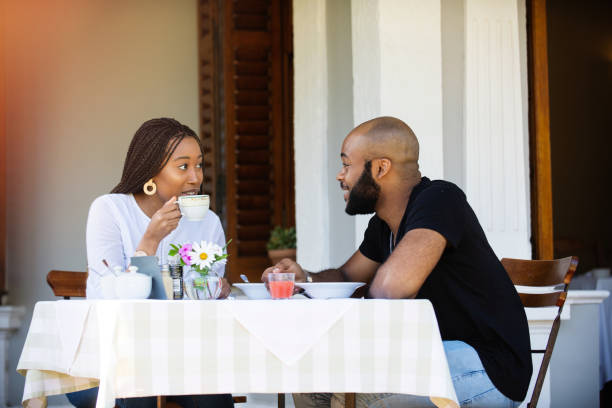 istock Couple on a restaurant veranda having a meal and an interesting conversation 1205497612