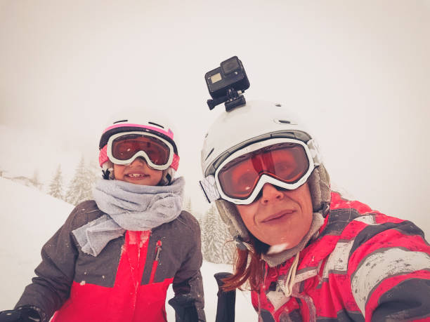 istock Family on winter vacations taking selfie on mountain slope. 1205497648