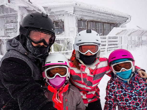 istock Family on winter vacations taking selfie on mountain slope. 1205497696