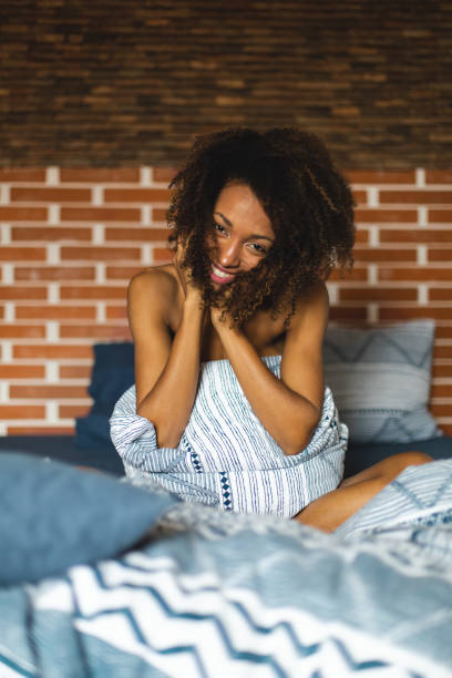 istock Beautiful woman at bed waking up 1205497858
