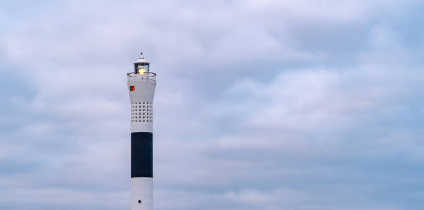 istock Long exposure of lighthouse tower with cloudy sky background 1205497906