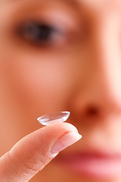 istock Contact lens balanced on woman's index finger 120549841