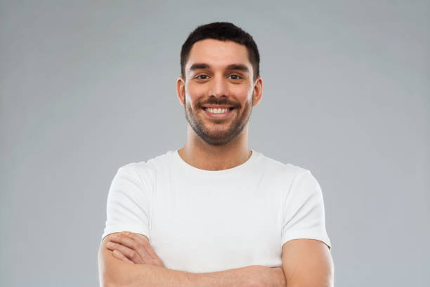 istock smiling man with crossed arms over gray background 1205501115