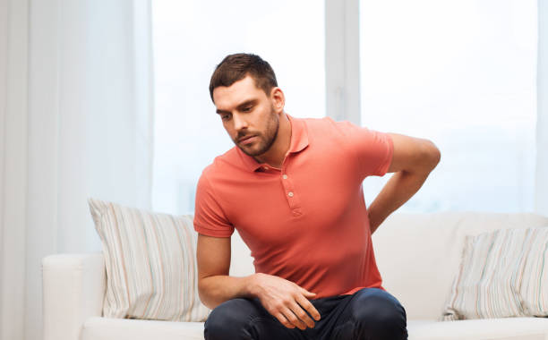 istock unhappy man suffering from backache at home 1205501151