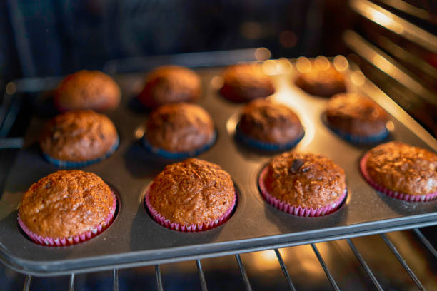 istock Tray  with muffins in oven 1205502855