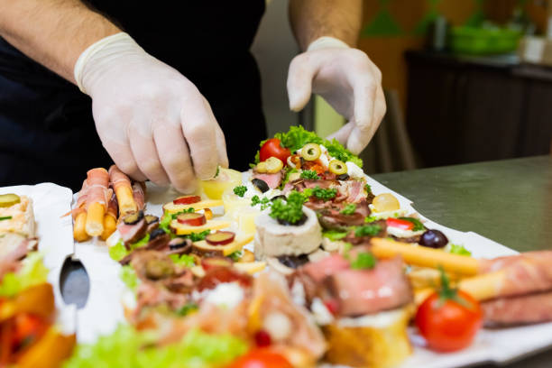 istock Chef preparing fresh finger food on paper plate for delivery. 1205504033