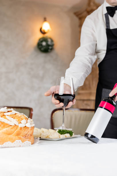 istock Man holding wine and decorated bread on table for celebration a saint in Orthodox faith. Serbian traditional and cultural heritage. 1205504328