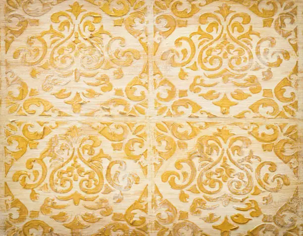 Photo of background of royal gold wooden vintage background with floral emboss details