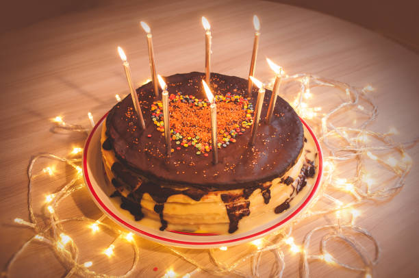 istock Home made cake with candles and decorated with red heart. 1205507861