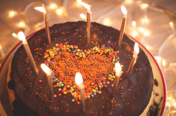 istock Home made cake with candles and decorated with red heart. 1205507867