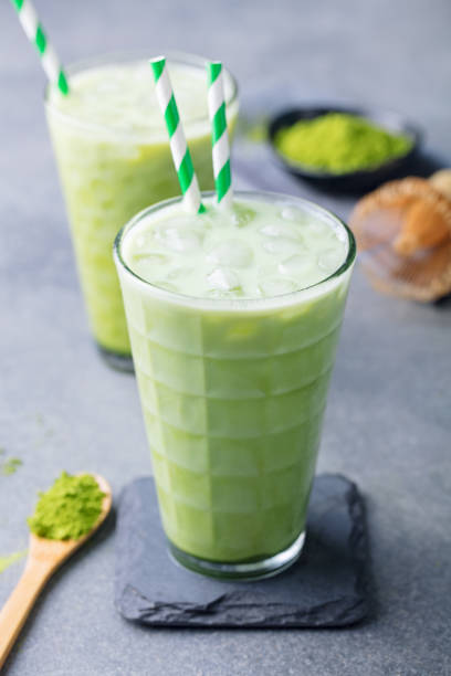 Matcha iced green tea. Grey background. Close up. Matcha iced green tea. Grey background. Close up. green tea cocktail bar stock pictures, royalty-free photos & images