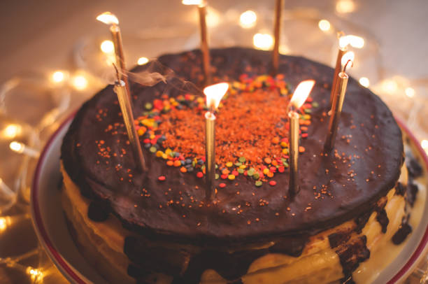 istock Home made cake with candles and decorated with red heart. 1205507891