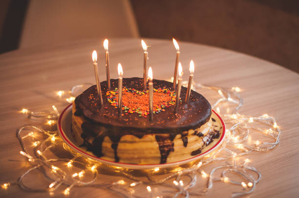 istock Home made cake with candles and decorated with red heart. 1205507953