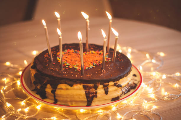 istock Home made cake with candles and decorated with red heart. 1205507958