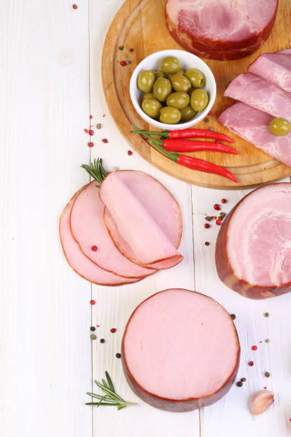 istock Assorted bacon, ham and olives on a white wooden table 1205509036