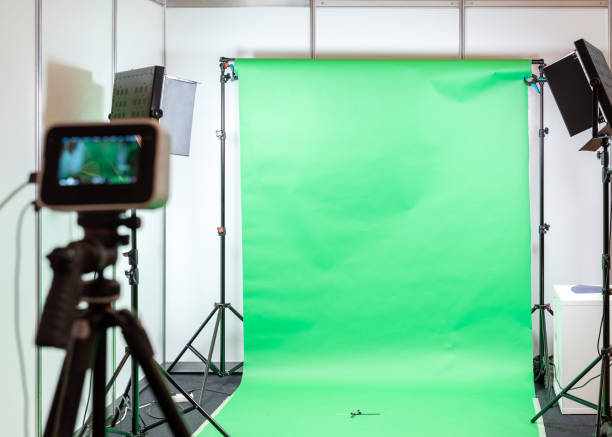 istock Green screen studio background. Filming or photography studio set with lights and filming equipment 1205509103