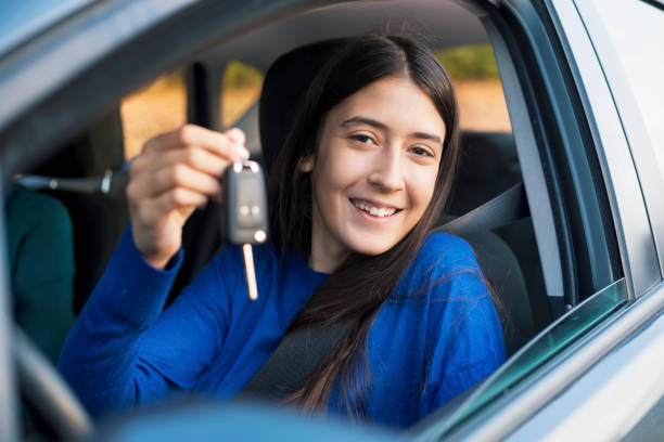 istock Teenager having driving lesson with female instructor 1205509321