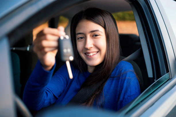 istock Teenager having driving lesson with female instructor 1205509322