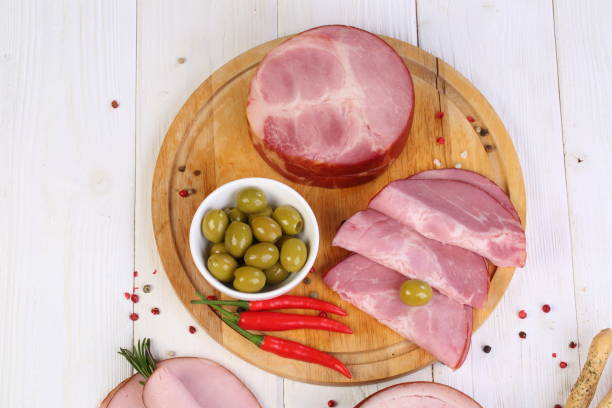 istock Assorted bacon, ham and olives on a white wooden table 1205509514