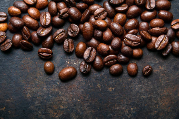 istock Coffee beans on a dark background. Coffee industry 1205510494